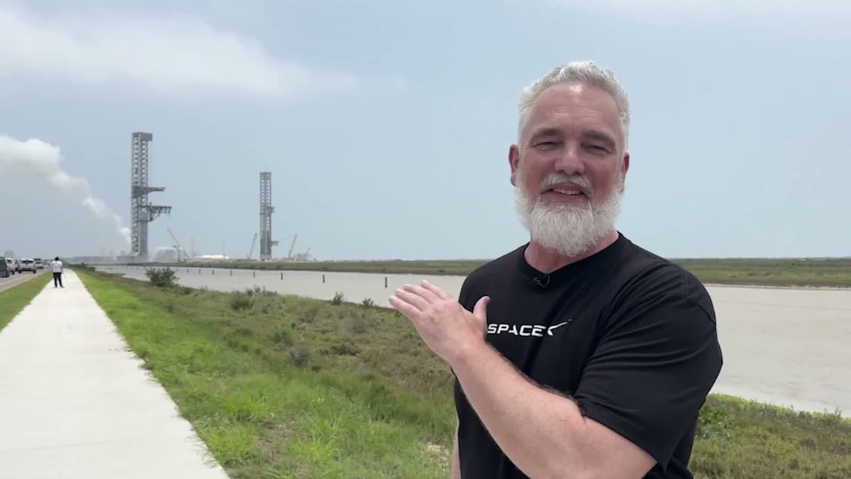 Jeff Brown at SpaceX's Starbase, Texas, with the launch towers behind him