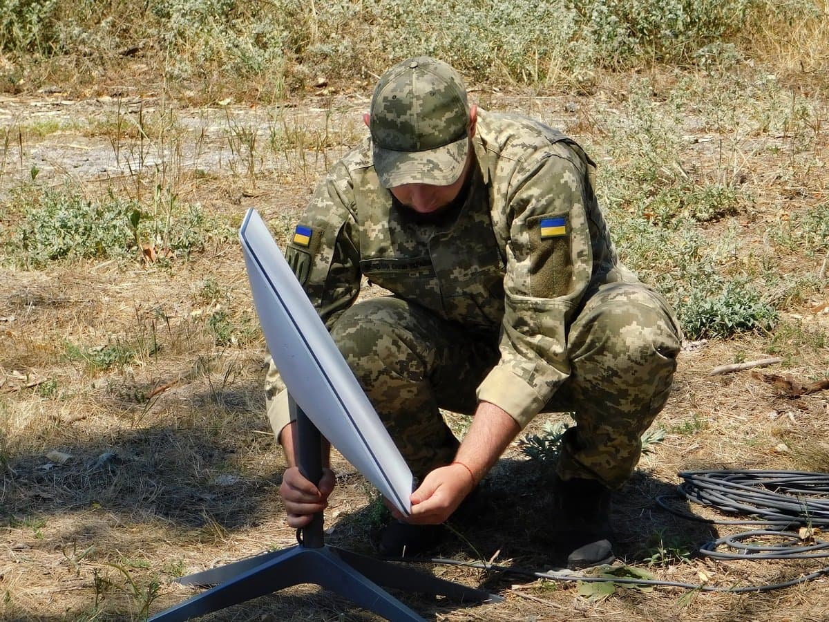 A Ukrainian soldier sets up a Starlink terminal in the field — SpaceX replaced the country's entire internet after Russia destroyed the telecom grid